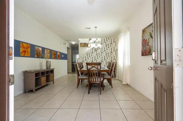 a view of a dining room with furniture and chandelier
