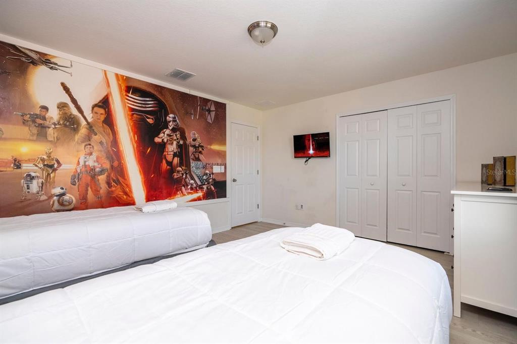 2625 Santosh Cove Kissimmee, FL 34746 - Photo 6 of 29 a bedroom with a large bed and a couch