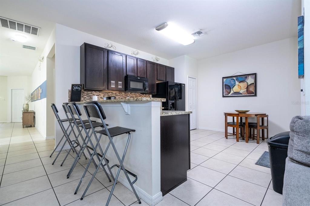 2625 Santosh Cove Kissimmee, FL 34746 - Photo 7 of 29 a view of a dining room with furniture