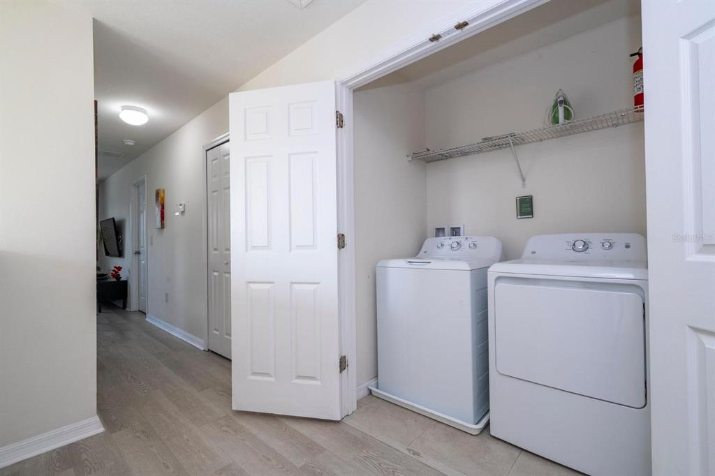 2625 Santosh Cove Kissimmee, FL 34746 - Photo 8 of 29 a view of storage and utility room with washer and dryer
