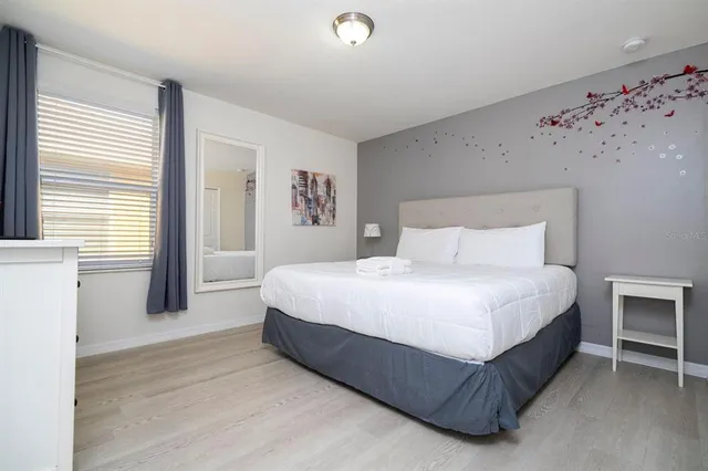 a spacious bedroom with a bed and a window