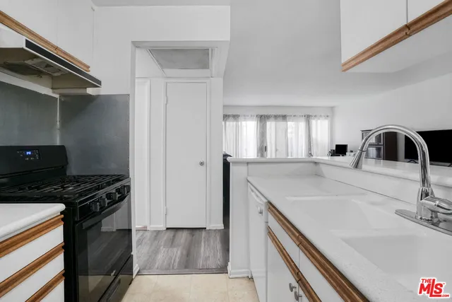 a bedroom with a bed and a large mirror on the dresser