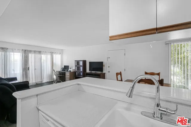 a kitchen with kitchen island a sink appliances and cabinets