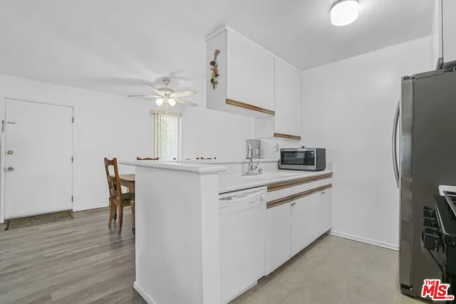 a kitchen with stainless steel appliances and a refrigerator