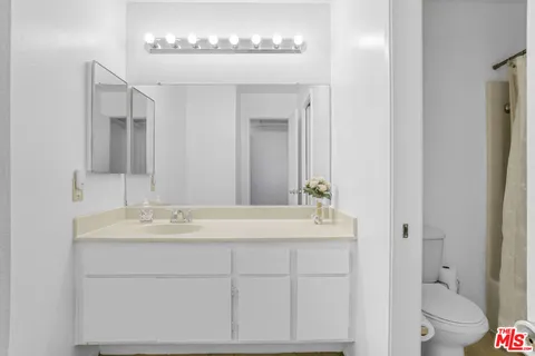 a bedroom with a bed and a night stand