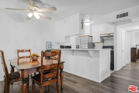 a dining room with furniture and wooden floor