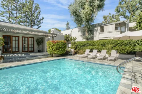 a view of a swimming pool with sitting area