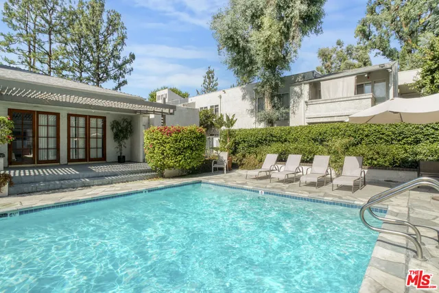 a view of a swimming pool with sitting area