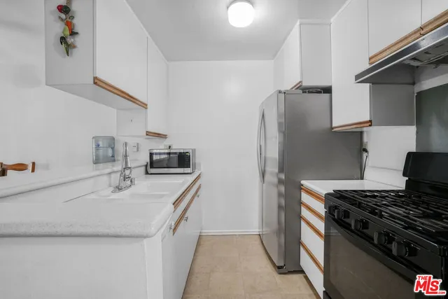 a kitchen that has a sink and a stove in it