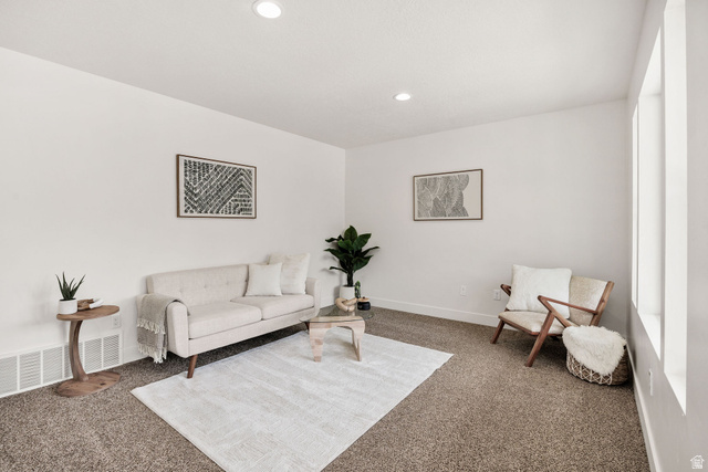 1552 Sumac Drive Logan, UT 84321 - Photo 4 of 72 Bright interior space featuring light-colored walls, recessed ceiling lighting, and a textured carpeted floor
