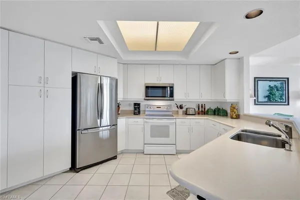 a kitchen with a sink appliances and cabinets