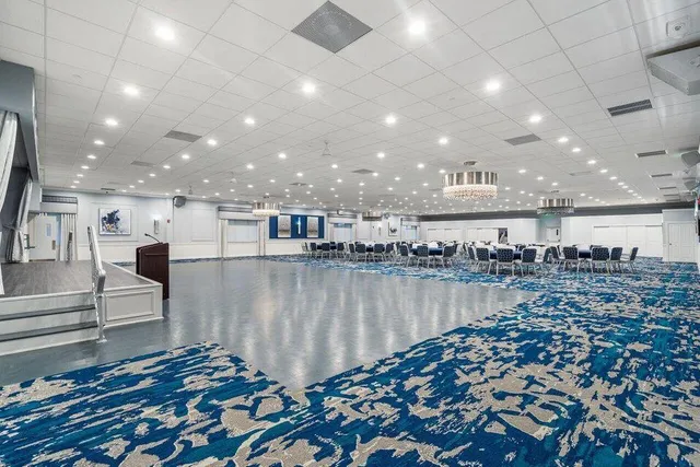 a room with lots of chairs and mirrors