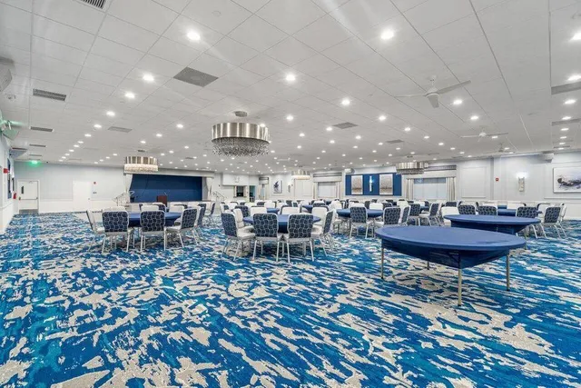 a view of an outdoor space kitchen with furniture and chandelier