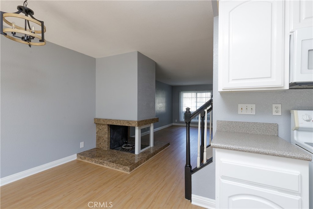 14256 Bolsa Chica Road Westminster, CA 92683 - Photo 2 of 15 a view of a livingroom with wooden floor and a fireplace