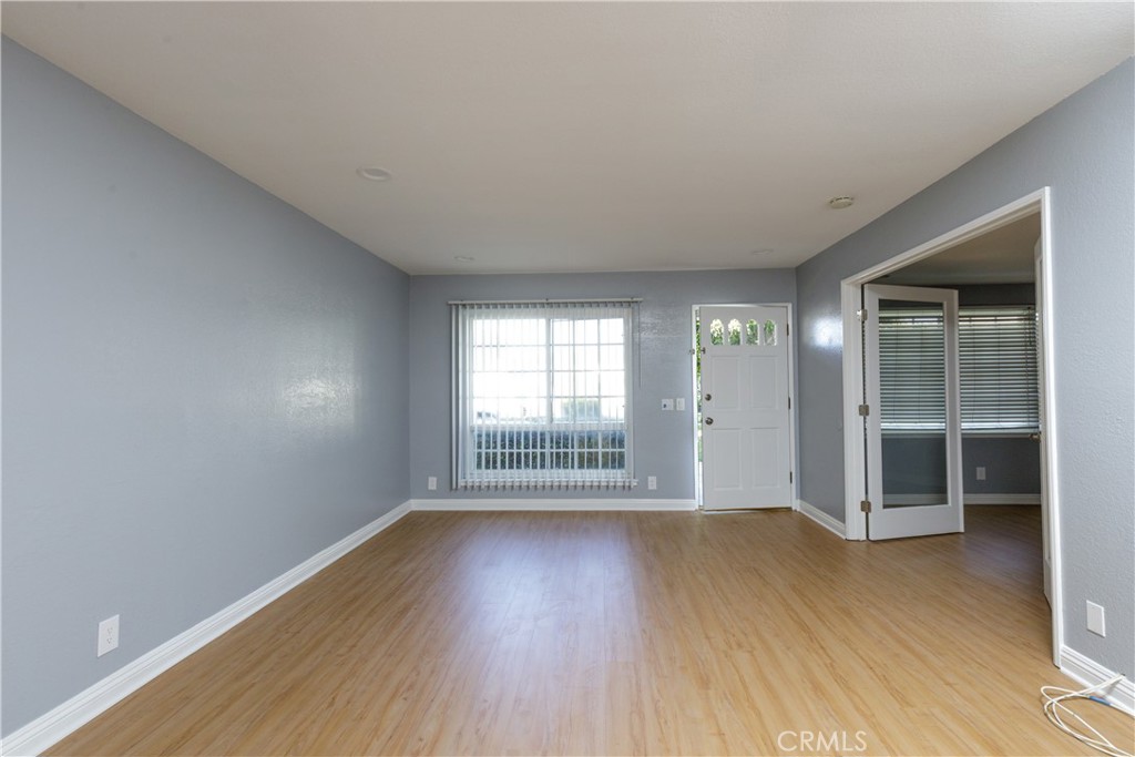 14256 Bolsa Chica Road Westminster, CA 92683 - Photo 3 of 15 an empty room with wooden floor and windows