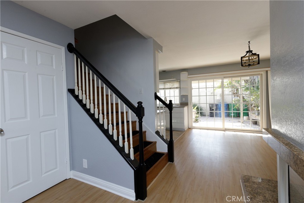 14256 Bolsa Chica Road Westminster, CA 92683 - Photo 6 of 15 a view of a hallway with wooden floor and windows