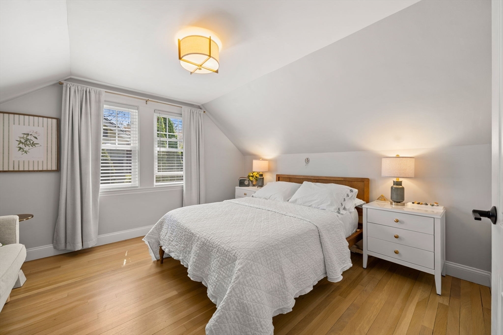 76 Perkins Street Stoneham, MA 02180 - Photo 24 of 40 a bedroom with a bed and wooden floor