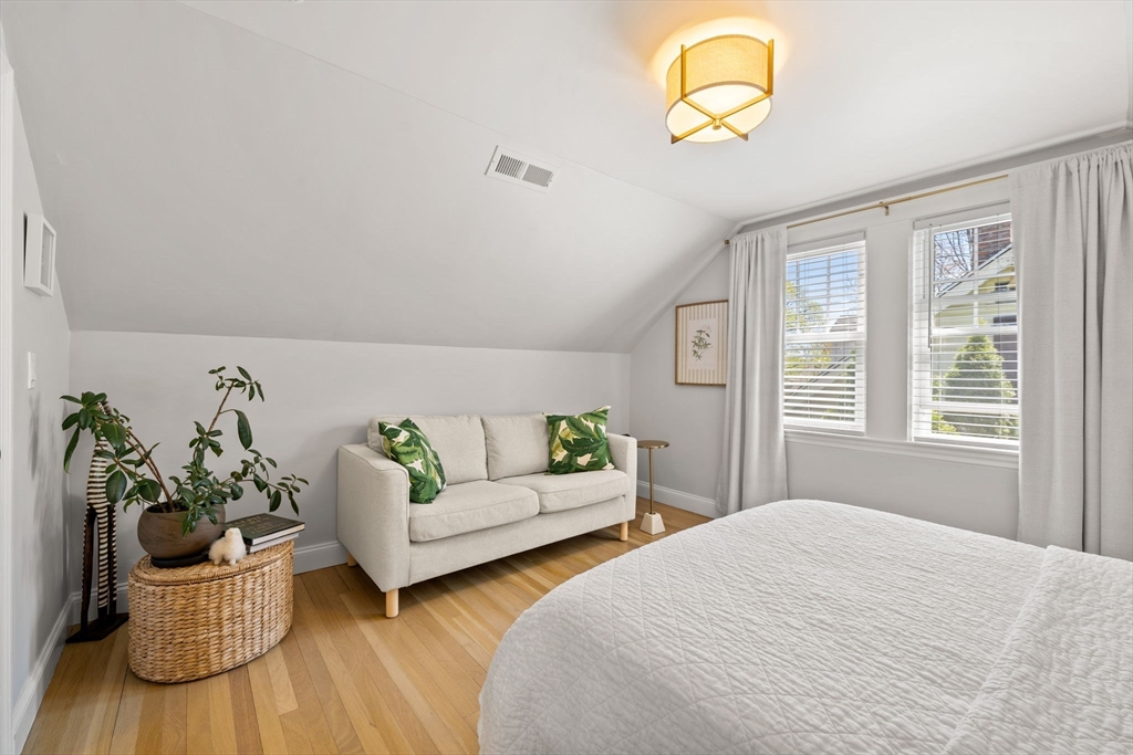 76 Perkins Street Stoneham, MA 02180 - Photo 25 of 40 a bedroom with furniture and a potted plant