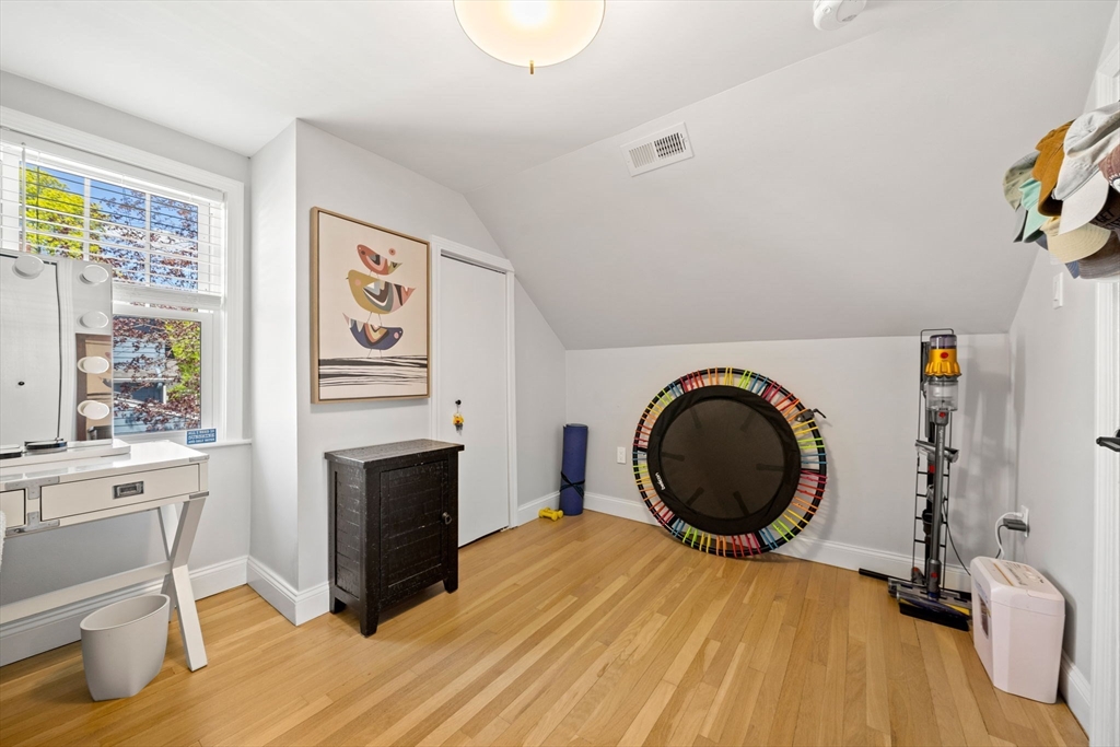 76 Perkins Street Stoneham, MA 02180 - Photo 27 of 40 a room with a washing machine and a fireplace