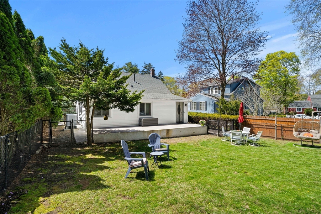 76 Perkins Street Stoneham, MA 02180 - Photo 32 of 40 a view of a house with backyard sitting area and tree