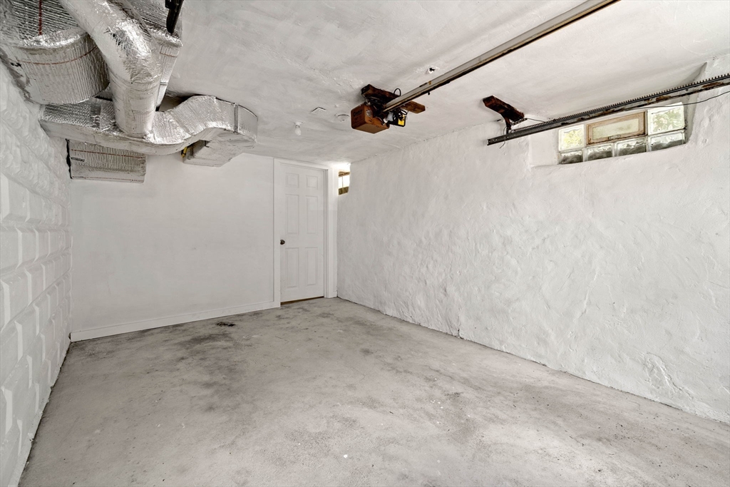 76 Perkins Street Stoneham, MA 02180 - Photo 40 of 40 an empty room with a ceiling fan and windows