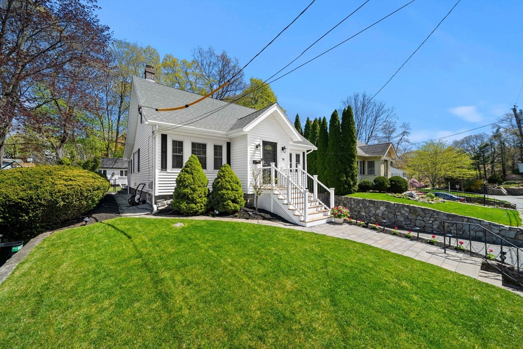 76 Perkins Street Stoneham, MA 02180 - Photo 4 of 40 a front view of a house with a garden