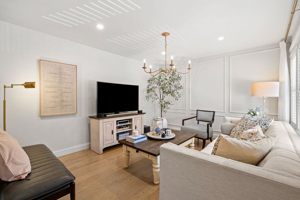 76 Perkins Street Stoneham, MA 02180 - Photo 6 of 40 a living room with furniture and a flat screen tv