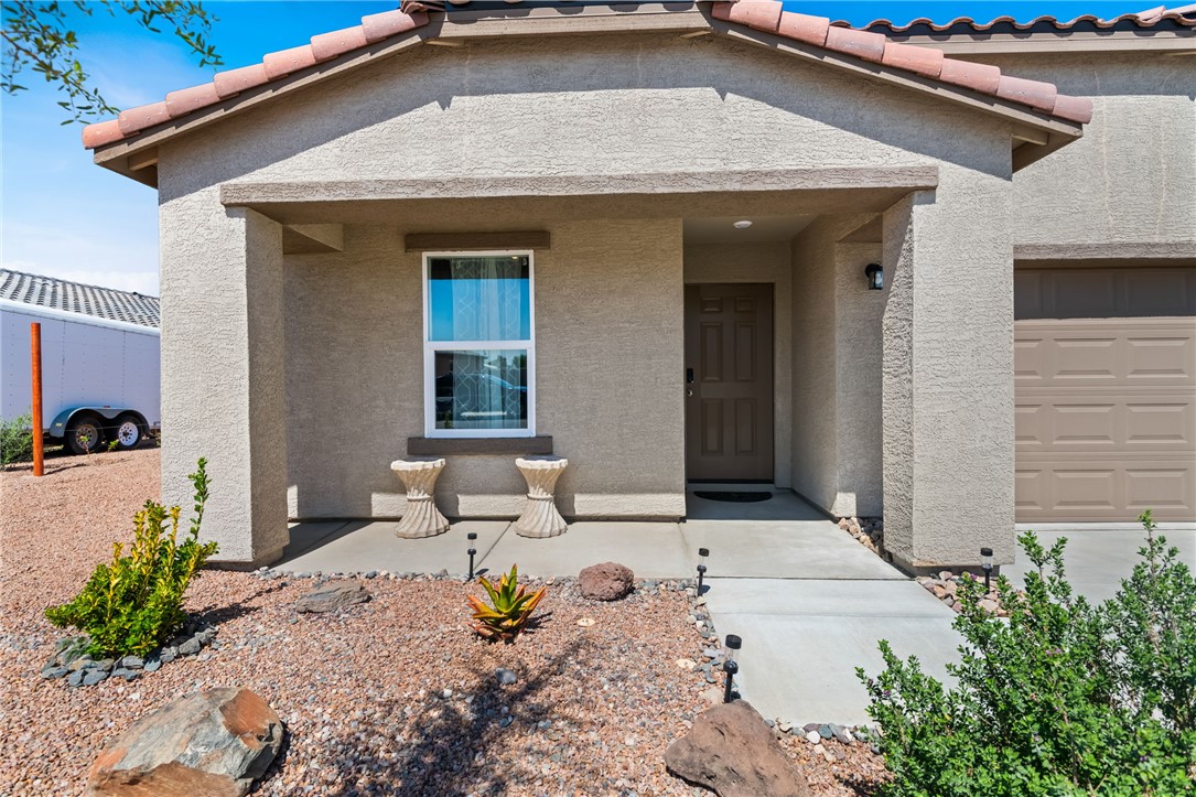 3623 East Andrea Drive Kingman, AZ 86409 - Photo 5 of 40 The property features a stucco exterior, a covered porch entry, and an attached garage