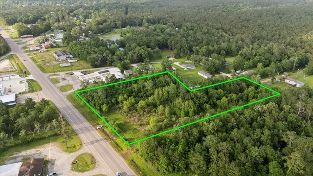 an aerial view of a residential houses with outdoor space and swimming pool