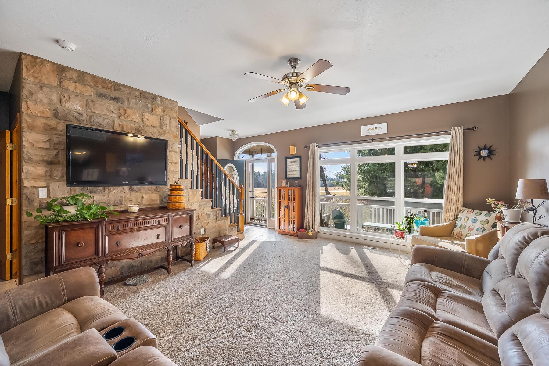 1704 Ford Road Delaware, OH 43015 - Photo 5 of 54 Sunny Living Room with Stone Wall