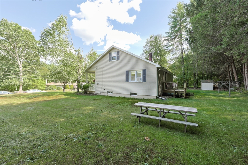 500 Worcester Road Barre, MA 01005 - Photo 21 of 24 a white bench sitting in the grass near a house