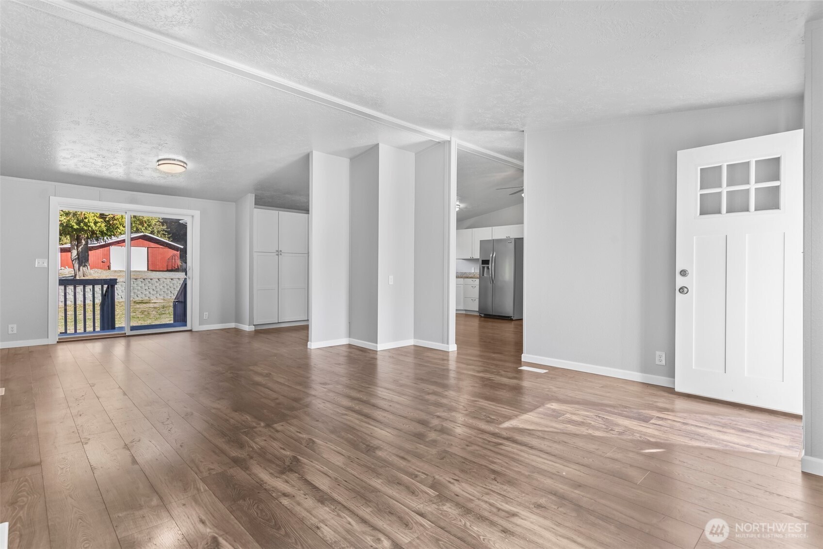6915 Stringtown Road East Eatonville, WA 98328 - Photo 9 of 40 a view of an empty room with wooden floor and entryway
