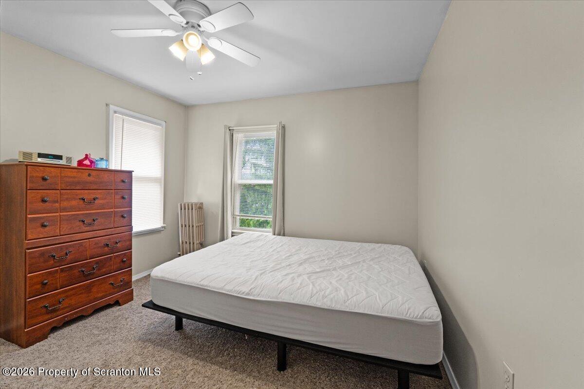 607 Deacon Street Scranton, PA 18509 - Photo 11 of 40 a bedroom with a bed and a chandelier