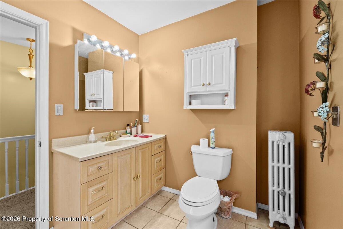 607 Deacon Street Scranton, PA 18509 - Photo 20 of 40 a bathroom with a toilet sink and mirror