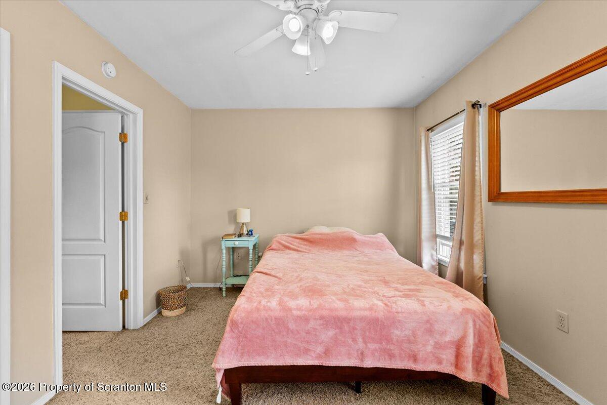 607 Deacon Street Scranton, PA 18509 - Photo 21 of 40 a bedroom with a bed and a chandelier