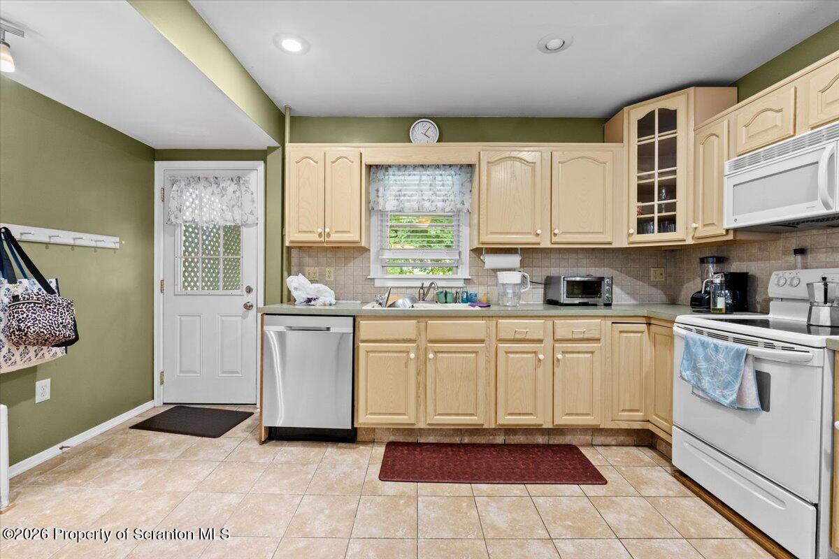 607 Deacon Street Scranton, PA 18509 - Photo 22 of 40 a kitchen with a refrigerator and white cabinets