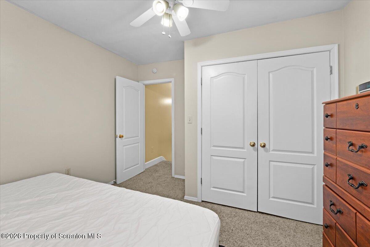 607 Deacon Street Scranton, PA 18509 - Photo 23 of 40 a bedroom with a bed and a chandelier