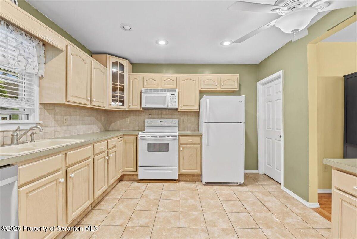 607 Deacon Street Scranton, PA 18509 - Photo 26 of 40 a kitchen with white cabinets and white appliances