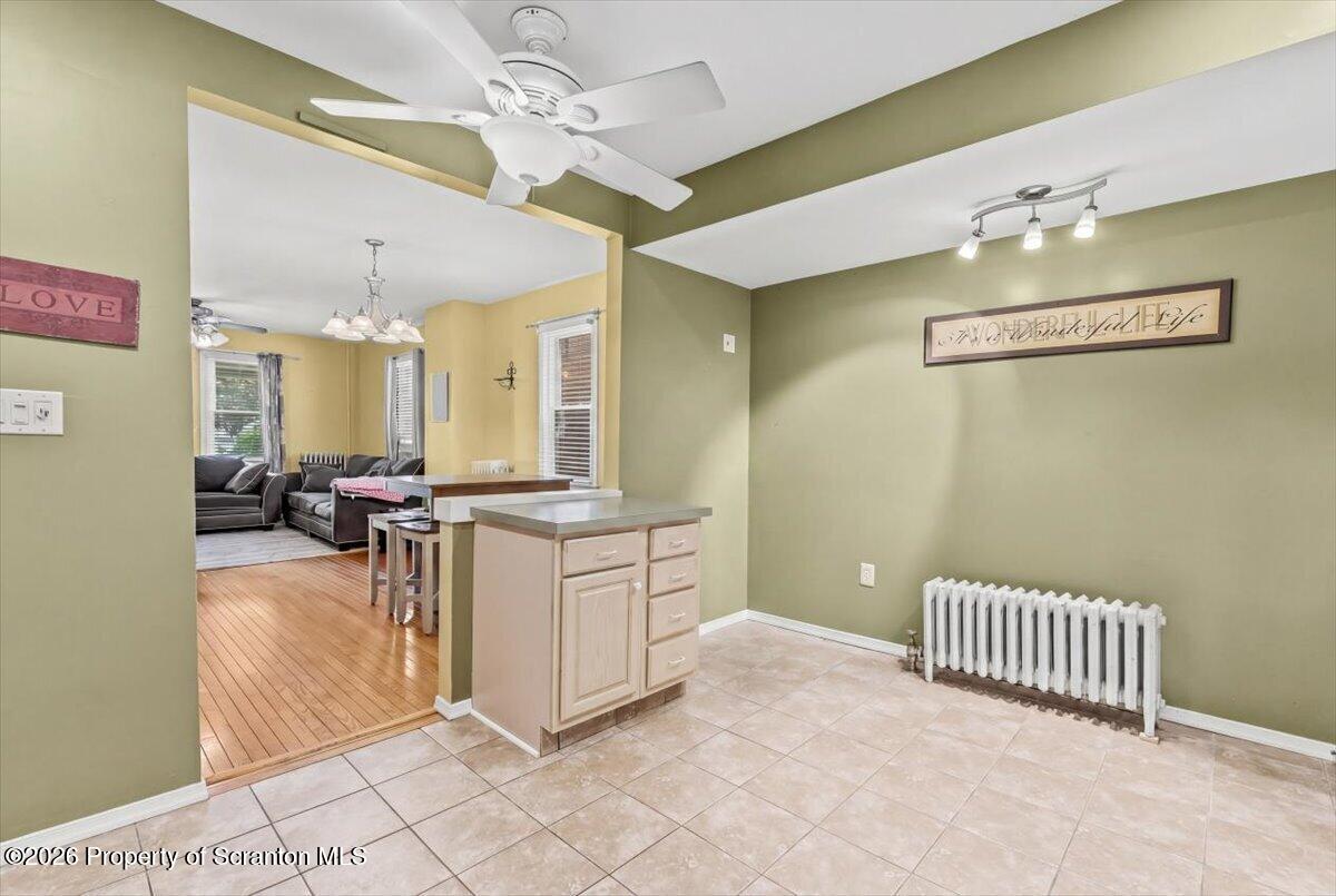 607 Deacon Street Scranton, PA 18509 - Photo 28 of 40 a view of a hallway with dining area and chandelier