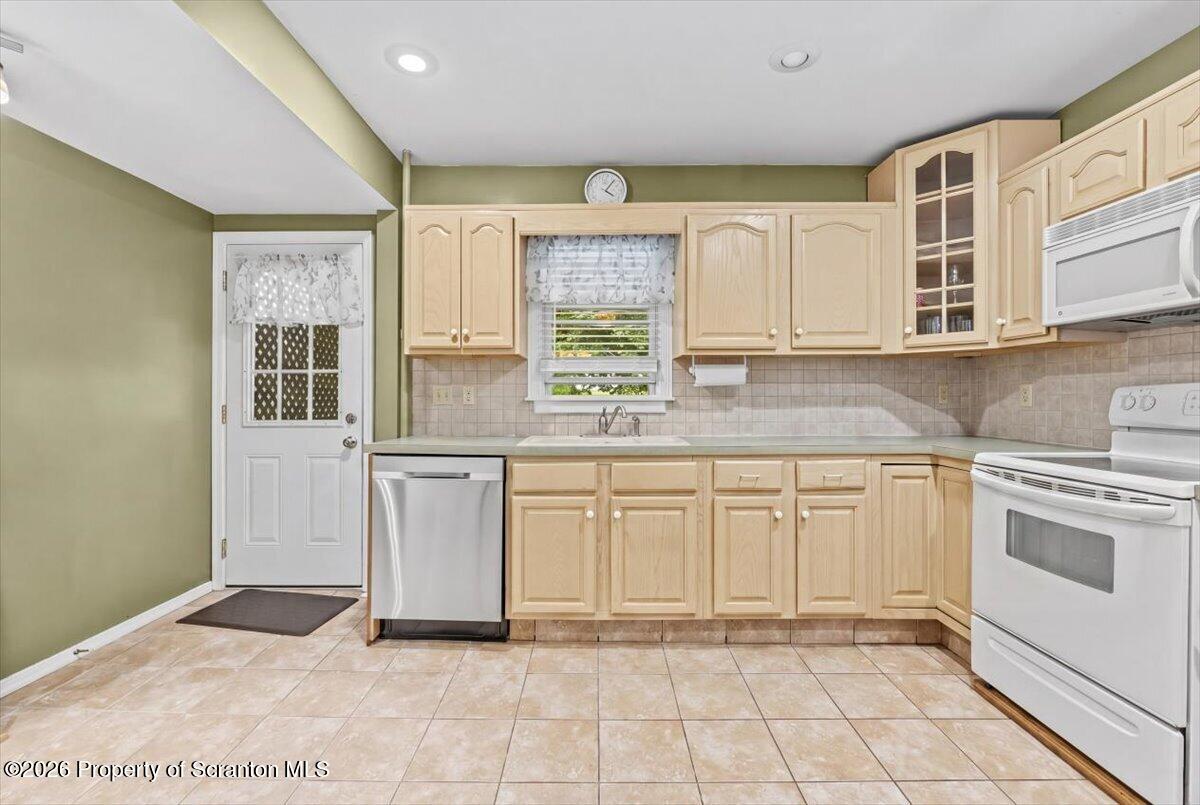 607 Deacon Street Scranton, PA 18509 - Photo 29 of 40 a kitchen with stainless steel appliances granite countertop a stove a sink and a microwave