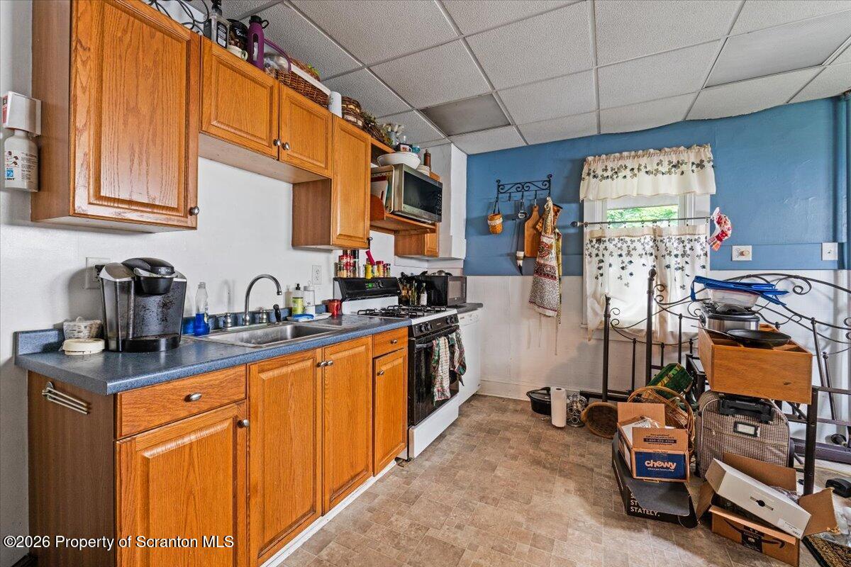 607 Deacon Street Scranton, PA 18509 - Photo 31 of 40 a kitchen with stainless steel appliances granite countertop a sink and cabinets