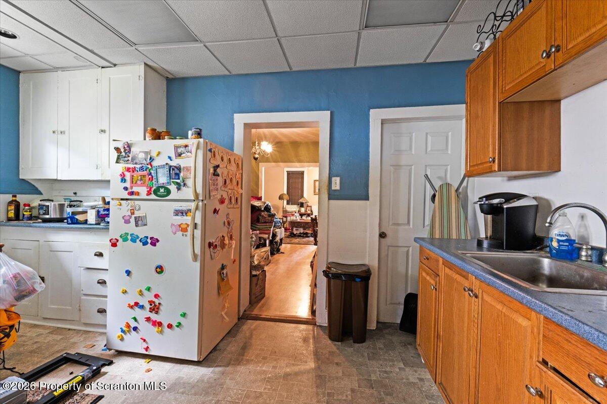 607 Deacon Street Scranton, PA 18509 - Photo 34 of 40 a kitchen with refrigerator and cabinets