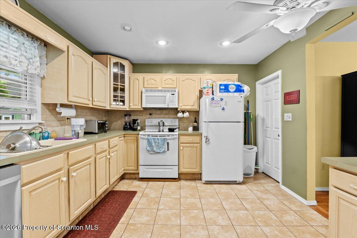 607 Deacon Street Scranton, PA 18509 - Photo 9 of 40 a kitchen with a refrigerator a sink dishwasher and cabinets with wooden floor