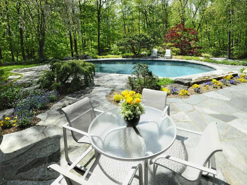 21 Mountain Wood Drive Greenwich, CT 06830 - Photo 18 of 20 a swimming pool with some trees in the background