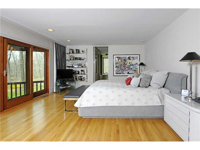 21 Mountain Wood Drive Greenwich, CT 06830 - Photo 10 of 20 a bed sitting in a bedroom next to a large window