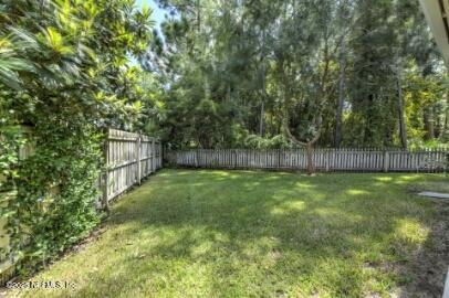 86192 Fortune Drive Yulee, FL 32097 - Photo 12 of 33 a view of a backyard with large trees and wooden fence