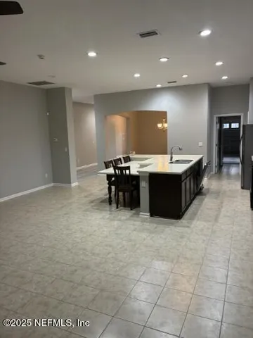 a kitchen with a refrigerator and cabinets