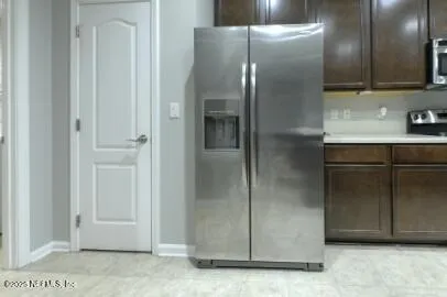 a kitchen with stainless steel appliances granite countertop a stove a refrigerator and a sink