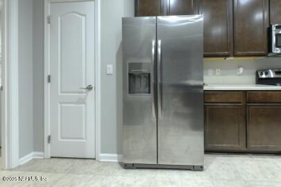 86192 Fortune Drive Yulee, FL 32097 - Photo 19 of 33 a kitchen with a refrigerator and cabinets