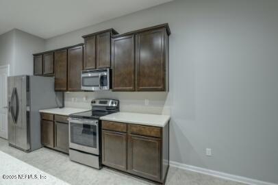 86192 Fortune Drive Yulee, FL 32097 - Photo 20 of 33 a kitchen with stainless steel appliances granite countertop a stove a refrigerator and a sink